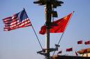 U.S. and Chinese national flags flutter on light post at Tiananmen Square ahead of welcoming ceremony for U.S. President Obama, in Beijing