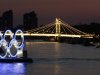 A boat passes a set of Olympic Rings floating in the River Thames off of Battersea park Tuesday, July 24, 2012, in London. The city will host the 2012 London Olympics with opening ceremonies scheduled for Friday, July 27.  (AP Photo/Charlie Riedel)
