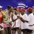 U.S. tennis players Serena Williams and her sister Venus greet children after exhibit tennis match in Johannesburg