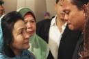 Rosmah Mansor, wife of Malaysian PM Najib Razak, cries with family members of passengers on the missing Malaysia Airlines flight MH370, in Putrajaya