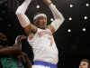 New York Knicks' Carmelo Anthony dunks over Boston Celtics' Jeff Green, left, and Shavlik Randolph during the first half of the NBA basketball game at Madison Square Garden, Sunday, March 31, 2013, in New York. (AP Photo/Seth Wenig)