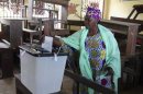 A woman casts her ballot at a polling station in Guinea's capital Conakry