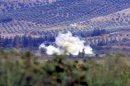 Smoke rises after a mortar bomb fired from Syria landed in Turkish soil on the Turkish-Syrian border in southern Hatay province