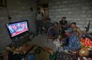 Members of the Iraqi armed forces watch Donald Trump giving a speech after he won the US presidential elections in November