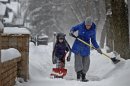 Amy Wolf and her daughter Audrey Wolf, 6, shovel the sidewalk on Friday, Feb. 22, 2013 in Minneapolis. A major snowstorm that buried parts of the Midwest grazed southern Minnesota, where two to three inches of snow snarled the morning commute in the Twin Cities area. (AP Photo/The Star Tribune, Elizabeth Flores) MANDATORY CREDIT; ST. PAUL PIONEER PRESS OUT; MAGS OUT; TWIN CITIES TV OUT