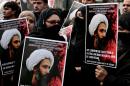 Citing longstanding differences that became a full-blown split after Saudi Arabia executed Shiite cleric and activist Nimr al-Nimr (pictured here on signs), Iranian FM Zarif said the Sunni-ruled kingdom had sought systematically to inflict damage