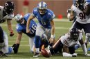 Detroit Lions quarterback Matthew Stafford chases the ball after a fumble and before Chicago Bears defensive end Julius Peppers recovers the ball during the first half of their NFL football game in Detroit,