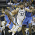 Memphis Grizzlies' Marc Gasol (33), of Spain, charges between Oklahoma City Thunder's DeAndre Liggins, left and Serge Ibaka, right, during the first half of Game 3 in a Western Conference semifinal NBA basketball playoff series in Memphis, Tenn., Saturday, May 11, 2013. (AP Photo/Danny Johnston)