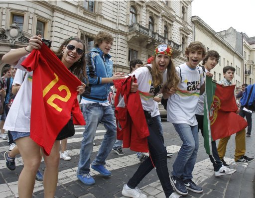 Portuguese fans hold flags and tee-shirts as they party in Lviv