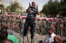 Protester shouts as he stands on top of a barricade in front of soldiers outside the Supreme Constitutional Court in Cairo