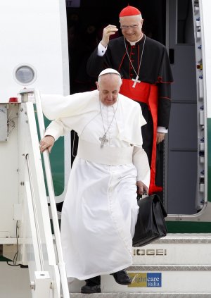 Pope Francis, holding his bag and followed by Vatican …
