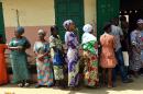 People queue oustide Zongo polling station as they wait to cast their ballot for the presidential run-off election in Cotonou, on March 20, 2016