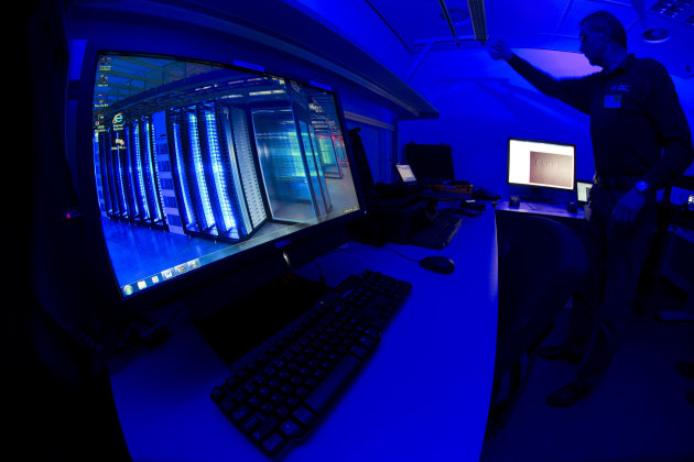 <p>               A member of the Cybercrime Center turns on the light in a lab during a media tour at the occasion of the official opening of the Cybercrime Center at Europol headquarters in The Hague, Netherlands, Friday Jan. 11, 2013. The lab is housed in a cage of Faraday and is used amongst others to analyze computer hard disks, mobile phones and smart phones. (AP Photo/Peter Dejong)