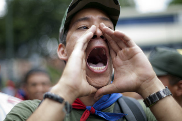 A 'Chavista' demonstrator shouts as supporters of President-elect Nicolas Maduro march in front of the National Electoral Council (CNE) in Caracas,Venezuela, Wednesday, April 17, 2013. Opposition candidate Henrique Capriles has presented a series of allegations of vote fraud and other irregularities to back up his demand for a vote-by-vote recount for the presidential election. (AP Photo/Ramon Espinosa)