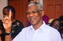 Presidential Candidate of the A Partnership for National Unity and Alliance For Change (APNU+AFC) David Granger displays his inked finger after voting at the Enterprise Primary School Georgetown Guyana, Monday, May 11, 2015. A party in power for over two decades in Guyana faced off in general elections Monday against a new coalition of opposition parties that seeks to challenge a tradition of racial politics and accuses the government of mismanagement and corruption. (AP Photo/Adrian Narine)