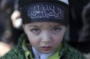 A Jordanian boy wears a headband with Arabic writing that reads "there is no God but Allah, and Mohammed is his Prophet." during a rally by Jordanian and Syrian followers of the banned Islamic-oriented Hizb Al-Tahrir, Liberation Party, after the Friday prayer in front of the Syrian embassy, in Amman, Jordan, Jan. 4, 2013. Hundreds of protesters shouted slogans proclaiming that Syria will have an Islamic state after the toppling of Bashar Assad and his regime. Russia's foreign minister said Saturday that Assad has no intention of stepping down and it would be impossible to try to persuade him otherwise. (AP Photo/Mohammad Hannon)