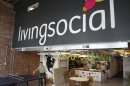 In this April 29, 2011 photo, Ross Arbes, 24, left, plays ping pong while on break at LivingSocial's offices in Washington. Online deals company LivingSocial announced Thursday, Nov. 29, 2012, it is cutting 400 jobs worldwide, or about 9 percent of its work force, as the deals market continues to face challenges. (AP Photo/Jacquelyn Martin, File)