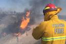 A firefighter watches the blaze after a gas line exploded near Fresno