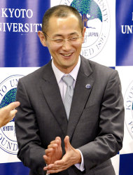Kyoto University Professor Shinya Yamanaka reacts as journalists applaud the Nobel Prize winner at the end of his news conference at the university in Kyoto, Japan, Monday night, Oct. 8, 2012. Yamanaka and British researcher John Gurdon won this year's Nobel Prize in physiology or medicine. (AP Photo/Kyodo News) JAPAN OUT, MANDATORY CREDIT, NO LICENSING IN CHINA, FRANCE, HONG KONG, JAPAN AND SOUTH KOREA