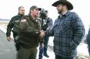 Harney County Sheriff Dave Ward meets with Ammon Bundy at a remote location outside the Malheur National Wildlife Refuge on Thursday, Jan. 7, 2016, near Burns, Ore. Three Oregon sheriffs met Thursday with the leader of an armed group occupying a federal wildlife refuge and asked them to leave, after residents made it clear they wanted them to go home. Ward said via Twitter that he asked Bundy to respect the wishes of residents. Ward said the two sides planned to talk again Friday. (Beth Nakamura/The Oregonian via AP)