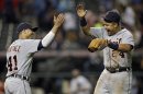 Detroit Tigers' Miguel Cabrera (24) celebrates with Victor Martinez (41) after a 4-2 win in 10 innings over the Cleveland Indians in a baseball game Monday, July 8, 2013, in Cleveland. Martinez drove in Cabrera and Prince Fielder with a double in the 10th for the win. (AP Photo/Mark Duncan)