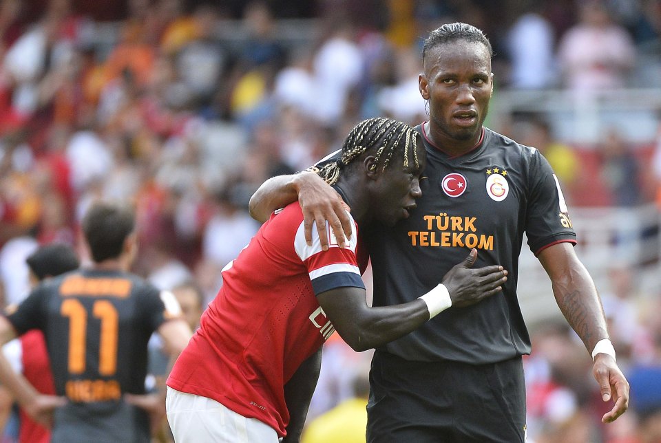 Didier Drogba of Galatasaray embraces Bacary Sagna of Arsenal following their pre-season Emirates Cup soccer match at Emirates Stadium in London