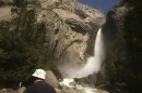 Visitor views Upper Yosemite Falls in Yosemite National Park