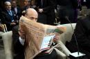 US Federal Reserve Chairman Ben Bernanke reads the Financial Times during the annual World Bank - International Monetary Fund (IMF) meetings in Washington, DC, October 12, 2013