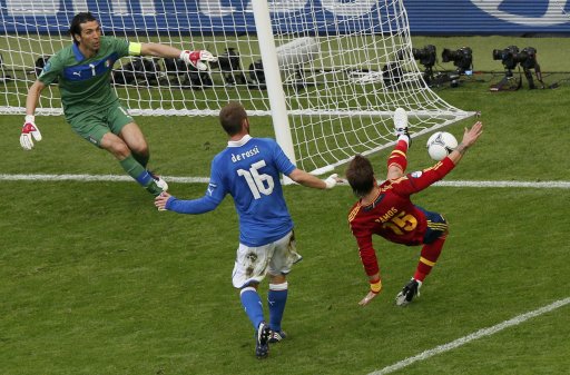 Spain's Ramos tries to kick the ball as Italy's Buffon and De Rossi react during their Group C Euro 2012 soccer match at the PGE Arena in Gdansk