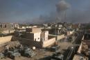 Smoke billows following a reported air strike by the US-led coalition on December 29, 2015 on the outskirts of Ramadi