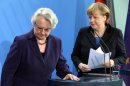German chancellor Angela Merkel , right, and education minister Annette Schavan, left, arrive for a statement in Berlin Saturday, Feb. 9, 2013. Germany's education minister has resigned after a university decided to withdraw her doctorate, finding that she plagiarized parts of her thesis - an embarrassment for Chancellor Angela Merkel's government months before national elections. (AP Photo/dpa, Wolfgang Kumm)