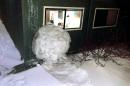 This Feb. 8, 2014 image provided by Reed College shows a large snowball that crashed into a Grove Quad dormitory at Reed College in Portland, Ore. The crash ripped a wall off its studs and narrowly missed a window. No one was injured in the collision. College officials say the ball was some 40 inches in diameter and weighed from 800 to 900 pounds.(AP Photo/Reed College)
