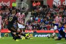 Tottenham's Harry Kane (2L) scores his team's fourth goal during their Premier League match against Stoke
