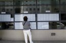 A woman looks at job listings in front of the Institute for Employment in Zagreb's downtown