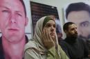 Monica Prieto (L), the wife of El Mundo correspondent Javier Espinosa (portrait-L) and Iraqi journalist Ghait Abdul-Ahad (R) look on during a press conference at the Samir Kassir Foundation offices in Beirut on December 10, 2013