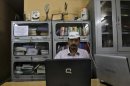Arvind Kejriwal, a social activist and anti-corruption campaigner, works on his laptop after his interview in Ghaziabad