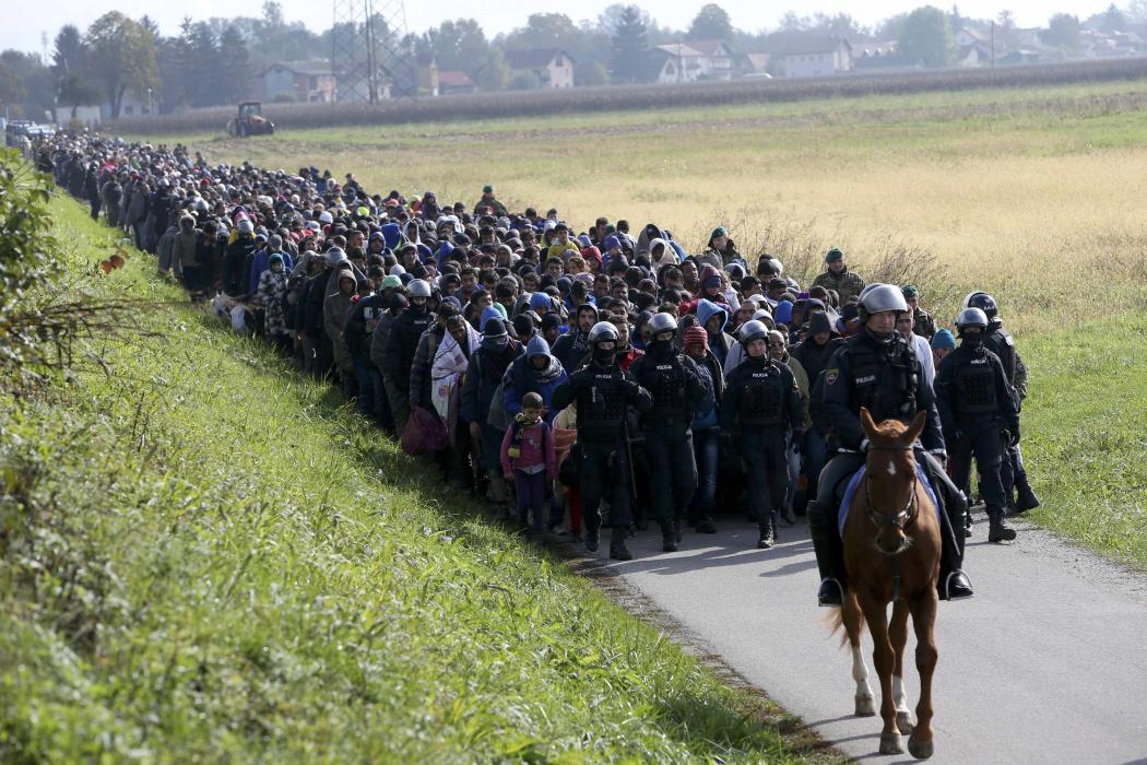 Migrants cross the Serbia-Croatia border after being stranded