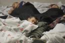 Detainees sleep in a holding cell at a U.S. Customs and Border Protection processing facility, in Brownsville