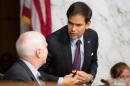 Senator Rubio speaks with Senator McCain as U.S. Secretary of State Kerry testifies during a Senate Foreign Relations Committee hearing on "U.S. Strategy to Defeat the Islamic State in Iraq and the Levant" on Capitol Hill