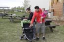 Philip Wylie, his wife, Suda, and their 13-month-old daughter Phaedra walk outside of an evacuation center in Lac La Biche, Alberta, Saturday, May 7, 2016. They are among more than 4,000 people who have come through the center this week. (AP Photo/Rachel La Corte)