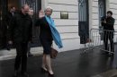 IMF chief Lagarde waves as she leaves after a hearing by French magistrates in Paris