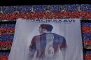 A giant banner of FC Barcelona Xavi Hernandez is displayed prior to the Spanish La Liga soccer match between FC Barcelona and Deportivo Coruna at the Camp Nou stadium in Barcelona, Spain, Saturday, May 23, 2015. Barcelona midfielder Xavi Hernandez says he will leave the Catalan club after 17 trophy-laden seasons in which he set club records for appearances and titles won. The 35-year-old Xavi, who has played 764 matches for Barcelona, says he will cut his contract short by one year and leave after this season to go play for Qatari club Al-Sadd on a two-year contract. (AP Photo/Manu Fernandez)