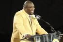 Warren Sapp talks during his acceptance into the NFL Pro Football Hall of Fame in Canton