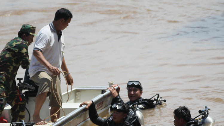 Divers search for bodies of victims of a crashed Lao Airlines plane in 