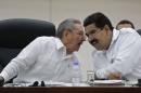 Cuba's President Castro talks to his Venezuelan counterpart Maduro during the opening ceremony of the ALBA-TCP Extraordinary Ebola summit in Havana
