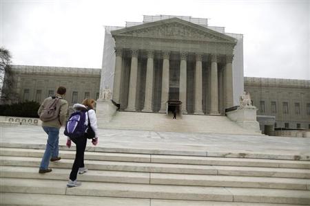 Tourists walk in front of the Supreme Court building in Washington, March 24, 2013. REUTERS/Jonathan Ernst