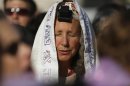 A member of "Women of the Wall" group wears a prayer shawl and Tefillin during a monthly prayer session at the Western Wall in Jerusalem's Old City