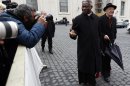 Cardinal Peter Kodwo Appiah Turkson, center, is photographed by the media as he arrives for an afternoon meeting, at the Vatican, Friday, March 8, 2013. The Vatican says the conclave to elect a new pope will likely start in the first few days of next week. The Rev. Federico Lombardi told reporters that cardinals will vote Friday afternoon on the start date of the conclave but said it was "likely" they would choose Monday, Tuesday or Wednesday. The cardinals have been attending pre-conclave meetings to discuss the problems of the church and decide who among them is best suited to fix them as pope. (AP Photo/Alessandra Tarantino)
