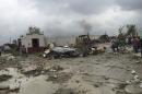 A bulldozer clears away debris after a powerful tornado swept past in Ciudad Acuna, northern Mexico, Monday, May 25, 2015. A tornado raged through the city on the U.S.-Mexico border Monday, destroying homes and flinging cars like matchsticks. At least 13 people were killed, authorities said. The twister hit a seven-block area, which Victor Zamora, interior secretary of the northern state of Coahuila, described as "devastated." (AP Photo)