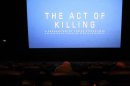 The opening of "The Act of Killing", a documentary made by Texan-born director Joshua Oppenheimer, is pictured during an underground screening at a theatre in Jakarta